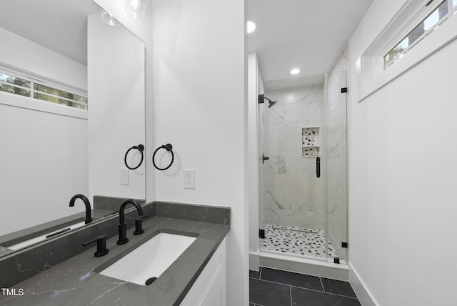 full bathroom featuring tile patterned flooring, recessed lighting, vanity, baseboards, and a marble finish shower