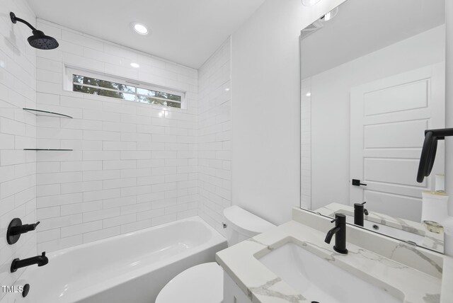 bathroom featuring toilet, recessed lighting, shower / bathing tub combination, and vanity