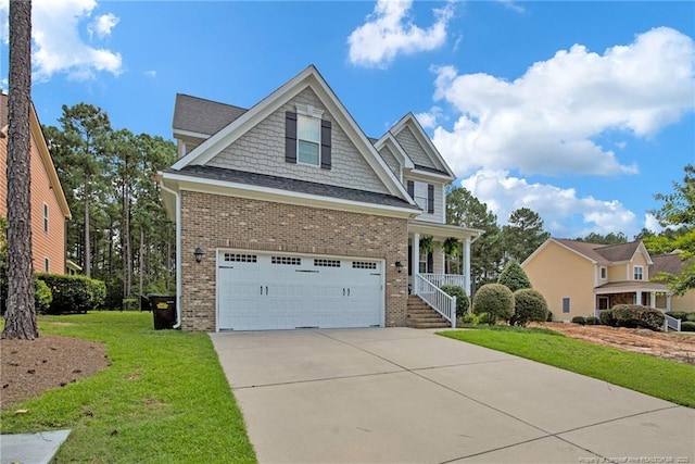 craftsman house with a front yard, a garage, and covered porch