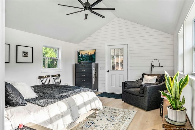 bedroom featuring lofted ceiling, light hardwood / wood-style flooring, and ceiling fan