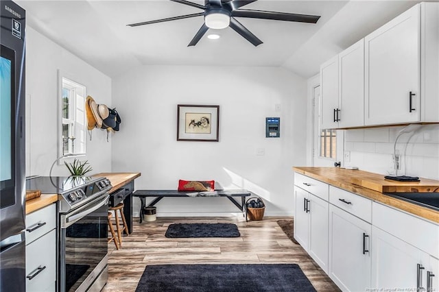 kitchen with light hardwood / wood-style flooring, backsplash, white cabinetry, lofted ceiling, and ceiling fan