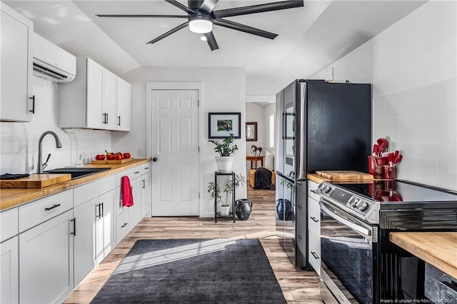 kitchen with light wood-type flooring, ceiling fan, white cabinetry, and sink