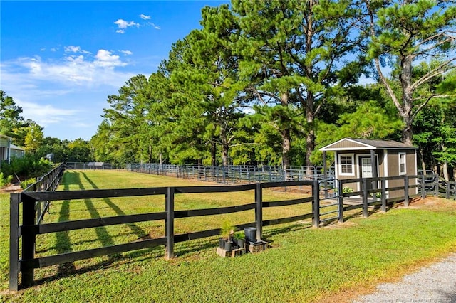 exterior space featuring a yard, an outbuilding, and a rural view