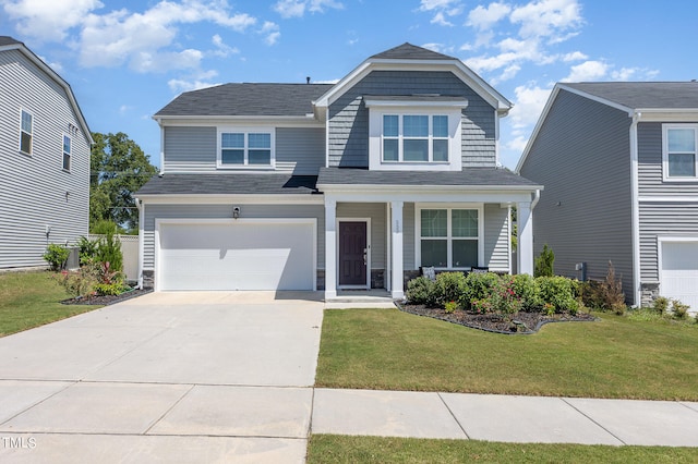 view of front of home with a garage and a front lawn