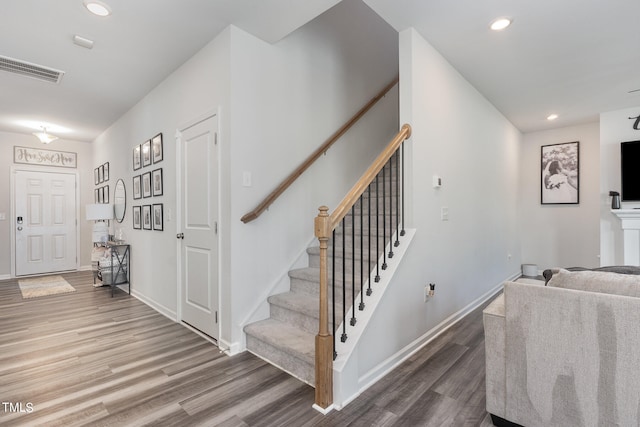 stairway with hardwood / wood-style flooring