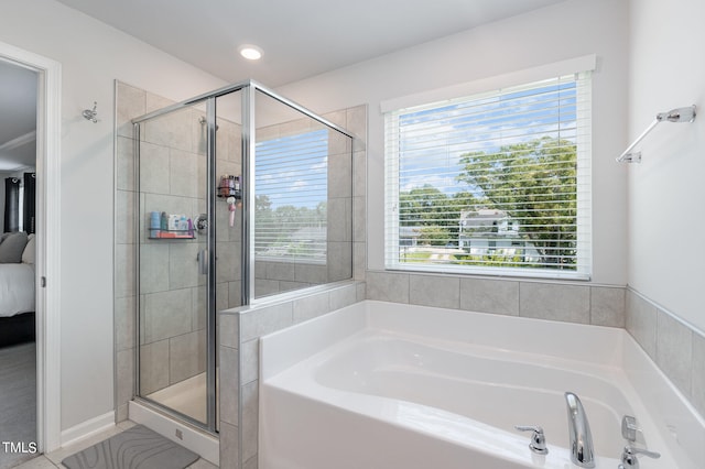 bathroom with plus walk in shower and a healthy amount of sunlight