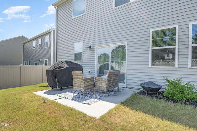 back of house featuring a patio area and a lawn