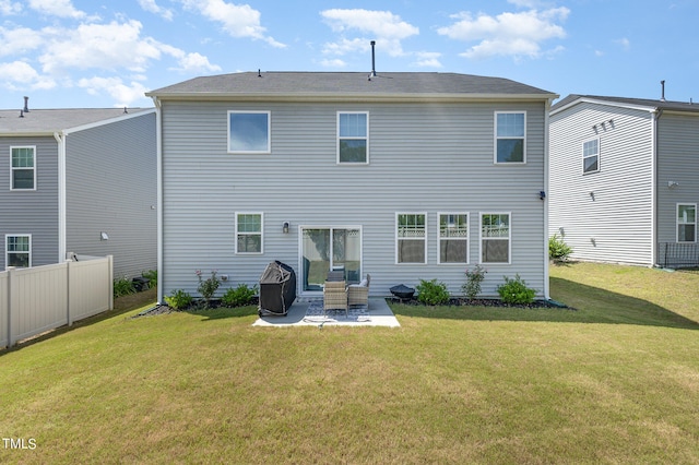 rear view of house featuring a patio and a lawn