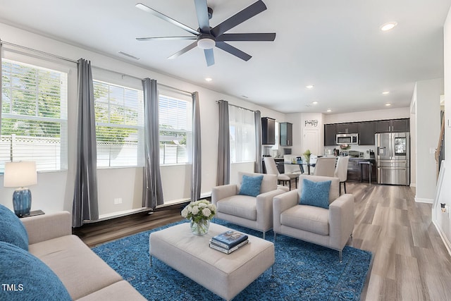 living room with dark hardwood / wood-style floors and ceiling fan