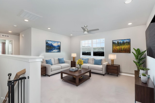 carpeted living room featuring ceiling fan