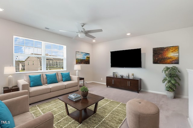 carpeted living room with ceiling fan