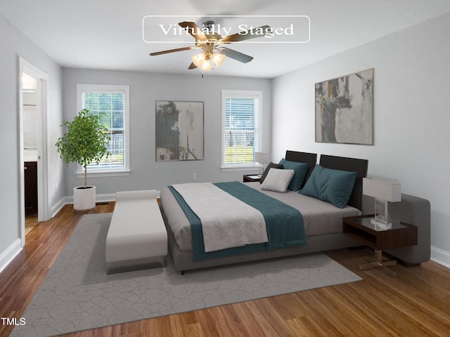 bedroom featuring ensuite bath, hardwood / wood-style floors, and ceiling fan