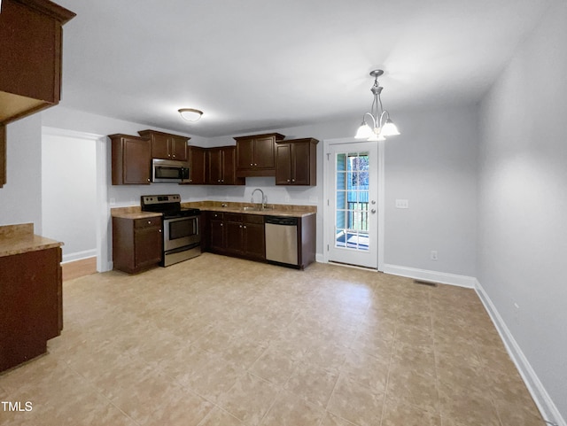 kitchen with an inviting chandelier, appliances with stainless steel finishes, sink, dark brown cabinetry, and light tile patterned flooring