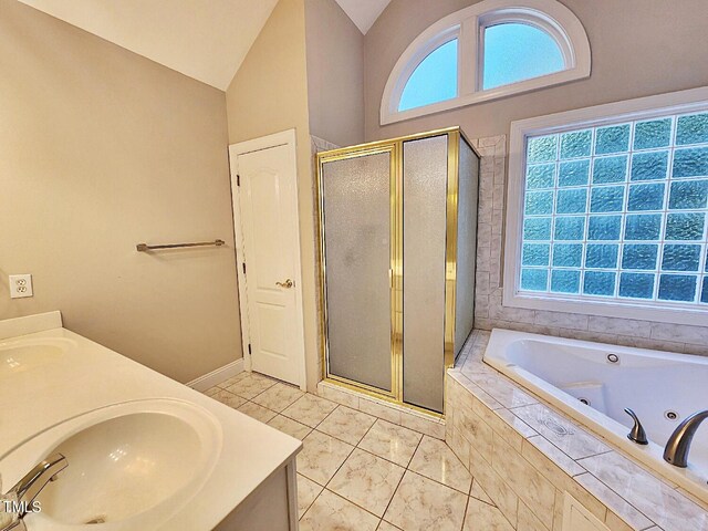 bathroom featuring plus walk in shower, tile patterned floors, plenty of natural light, and vanity