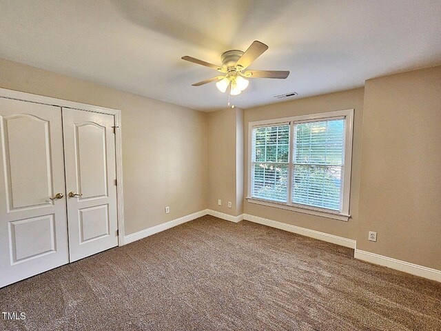 unfurnished bedroom with a closet, ceiling fan, and carpet