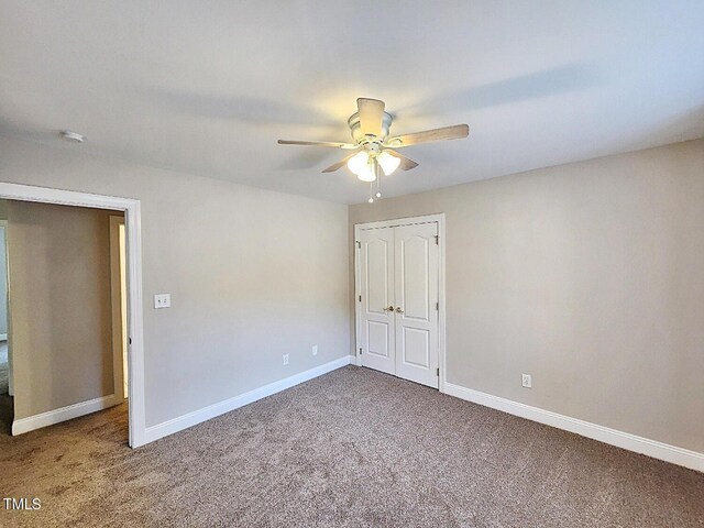 interior space featuring ceiling fan and carpet