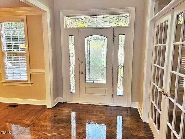 foyer entrance with dark hardwood / wood-style floors