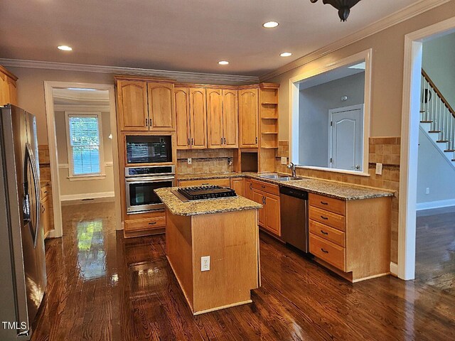 kitchen with a center island, backsplash, dark wood-type flooring, and stainless steel appliances