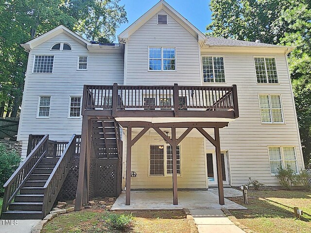 rear view of house with a patio area and a wooden deck