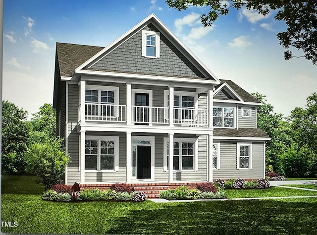 view of front of home with a balcony and a front lawn