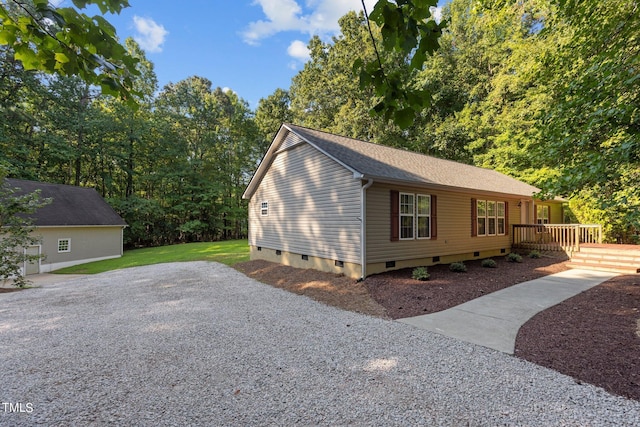 view of home's exterior featuring a shingled roof, crawl space, and a lawn