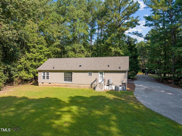 view of property exterior featuring cooling unit and a lawn