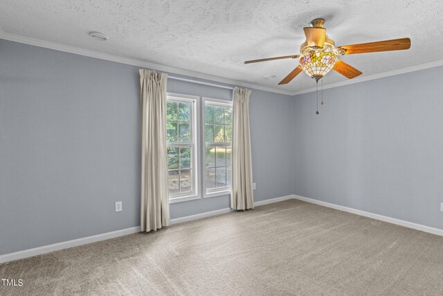 carpeted spare room with a textured ceiling, ceiling fan, and ornamental molding