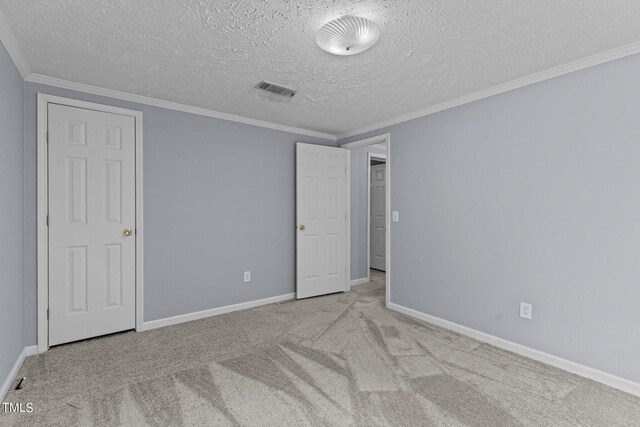 interior space featuring light colored carpet, crown molding, and a textured ceiling