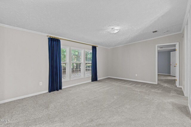 carpeted empty room featuring ornamental molding and a textured ceiling