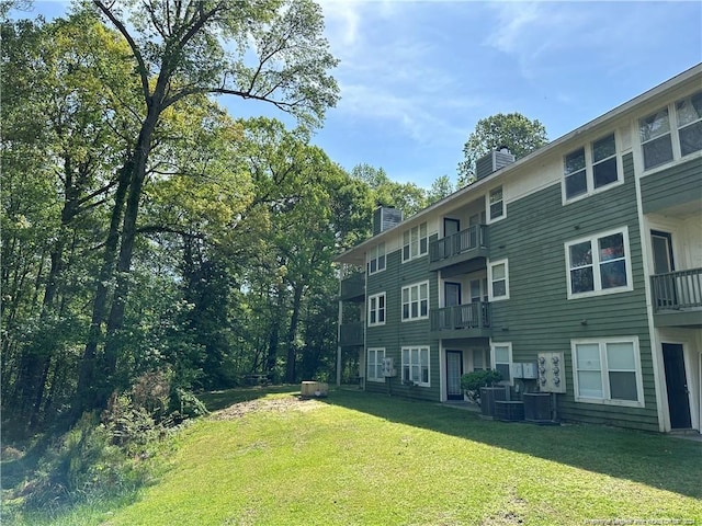 view of yard featuring a balcony and cooling unit