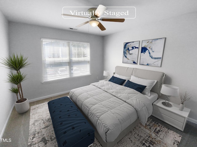 carpeted bedroom with baseboards, visible vents, and a ceiling fan