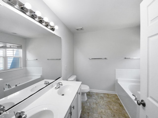 bathroom featuring a bath, visible vents, toilet, and a sink