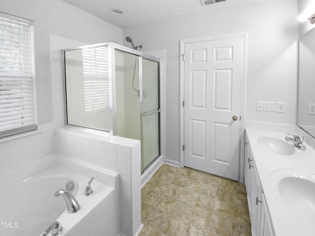 bathroom featuring a sink, a bath, and a shower stall