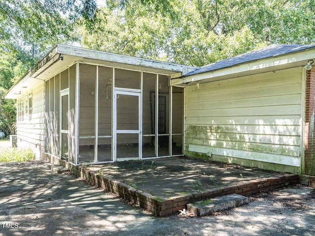 view of side of property with a sunroom