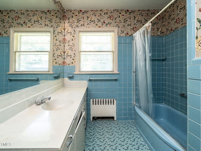 bathroom with vanity, shower / bath combo, radiator, and plenty of natural light