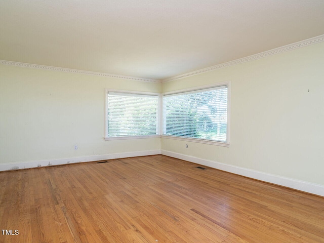 empty room with light hardwood / wood-style flooring