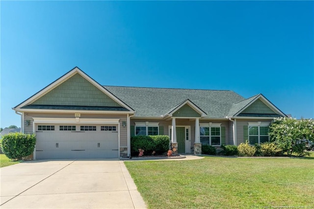 craftsman-style house featuring a garage and a front yard