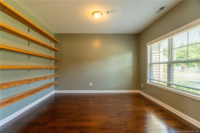 unfurnished room featuring dark hardwood / wood-style floors