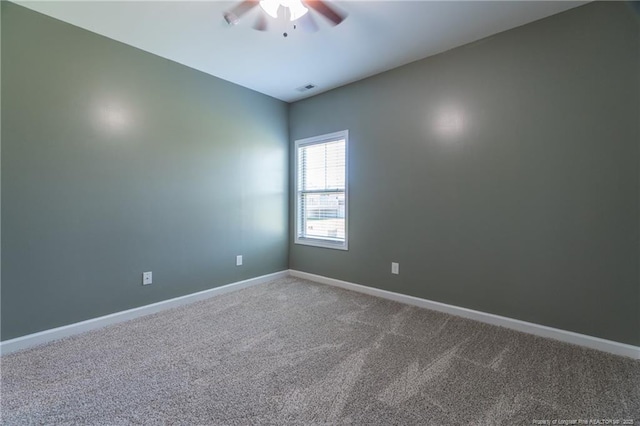 spare room featuring carpet floors and ceiling fan