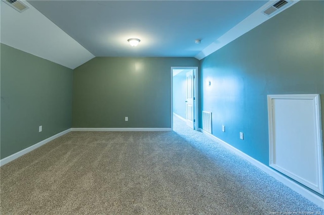 bonus room featuring lofted ceiling and carpet flooring