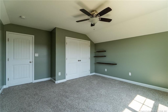 unfurnished bedroom with ceiling fan, lofted ceiling, carpet flooring, and a closet