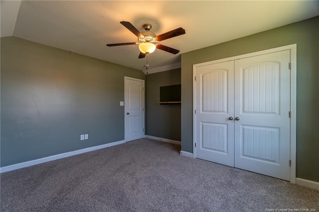 unfurnished bedroom with ceiling fan, lofted ceiling, carpet floors, and a closet