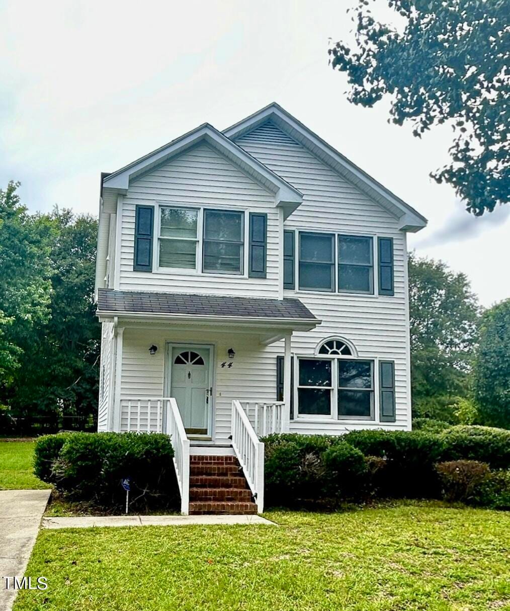 view of front facade with a front lawn and covered porch