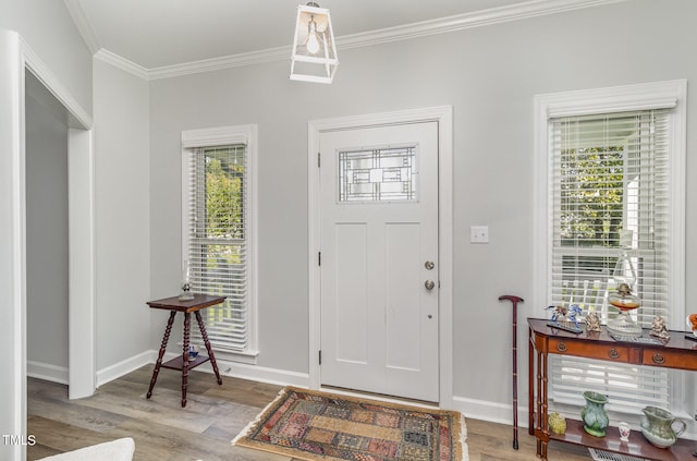 foyer with light hardwood / wood-style flooring and ornamental molding