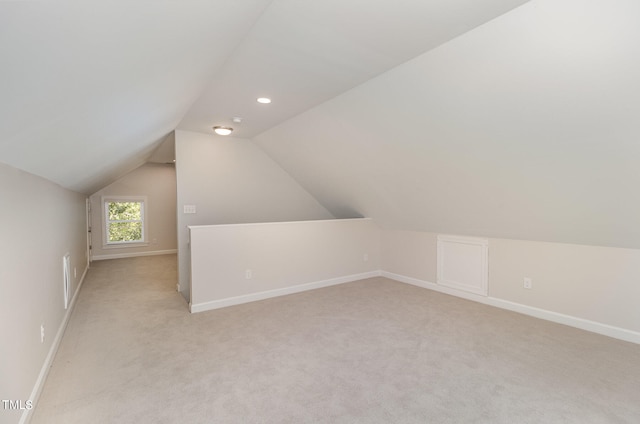 bonus room featuring light carpet and lofted ceiling