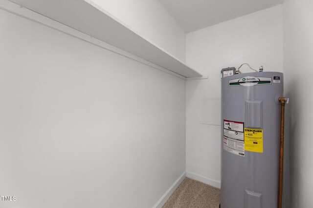 utility room featuring electric water heater