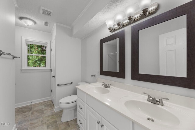 bathroom with crown molding, vanity, a textured ceiling, and toilet