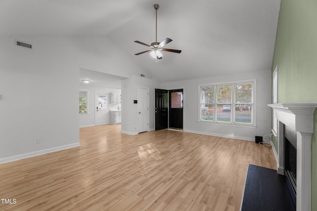 unfurnished living room with light wood-type flooring, high vaulted ceiling, and ceiling fan