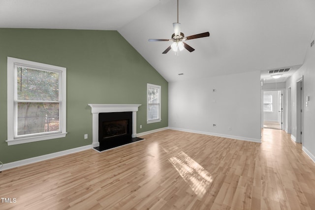 unfurnished living room with high vaulted ceiling, light hardwood / wood-style flooring, and ceiling fan