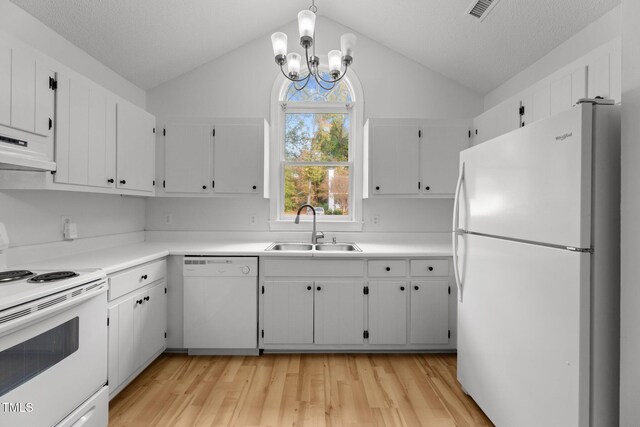 kitchen with white appliances, white cabinetry, vaulted ceiling, and sink